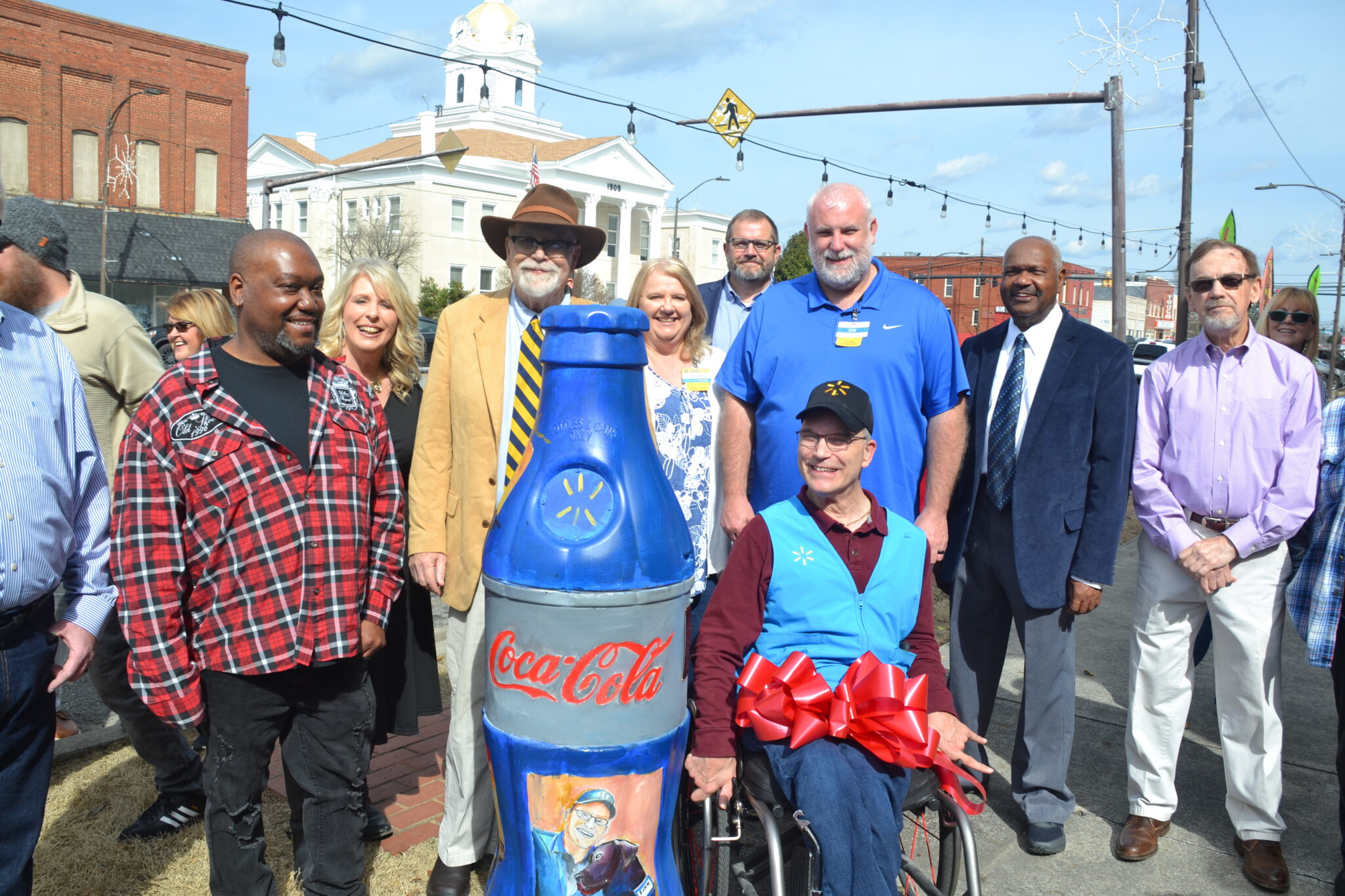Spann Cordle pictured with other people, next to an art intallation made in his honor